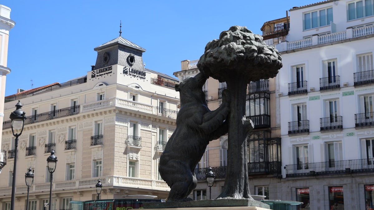 Iconic Bear and Strawberry Tree statue in Madrid's bustling Puerta del Sol.